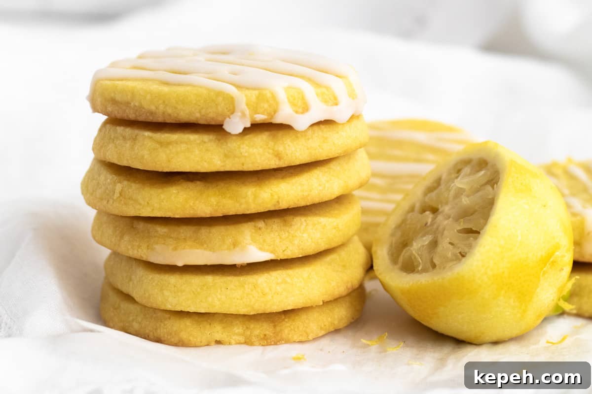 Buttery Lemon Shortbread Cookie Recipe 7 a stack of lemon shortbread with a zested lemon next to it