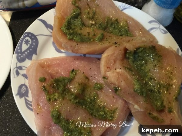 Preparing the chicken with pesto
