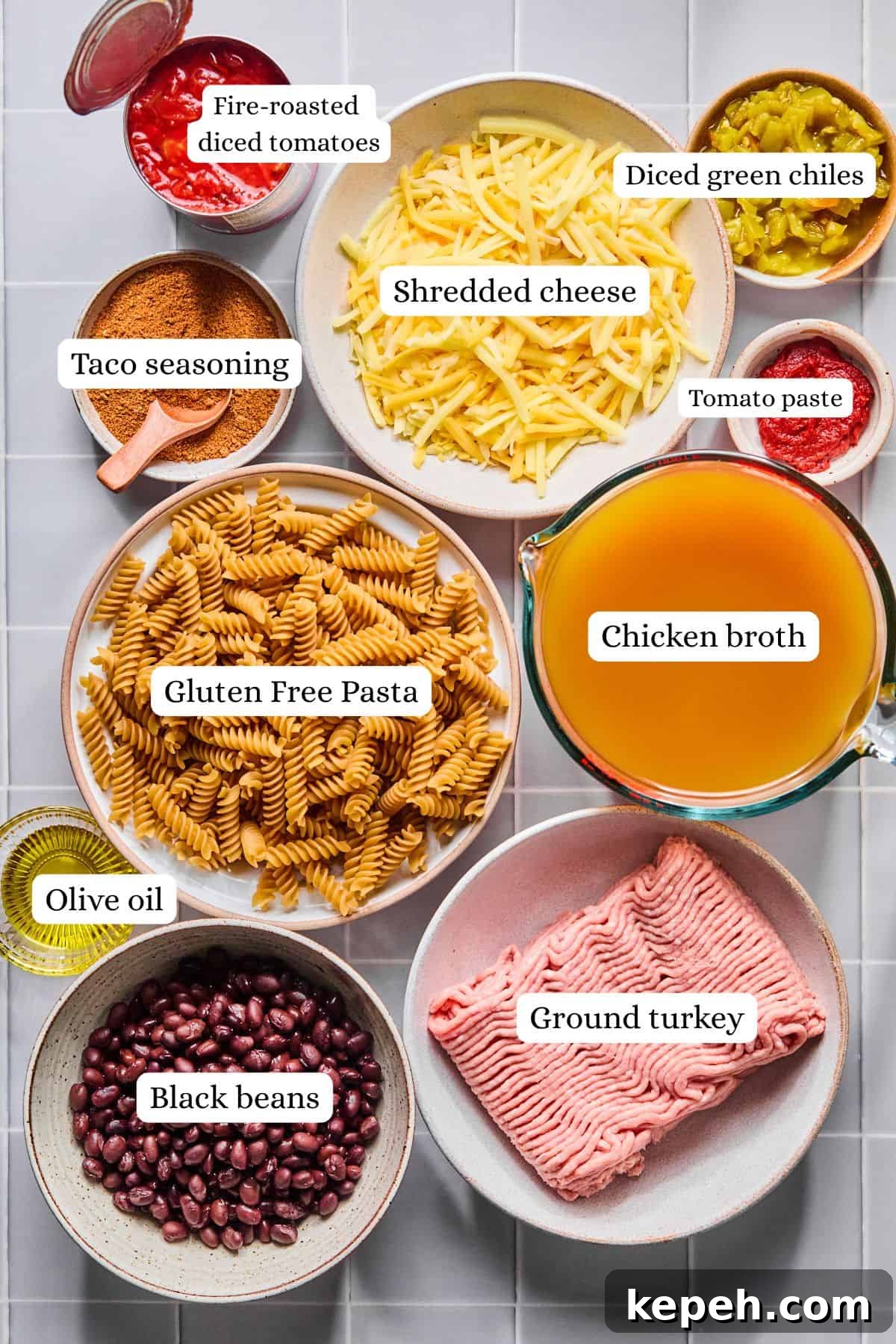 Ingredients for one pot taco pasta arranged in labeled nesting bowls.