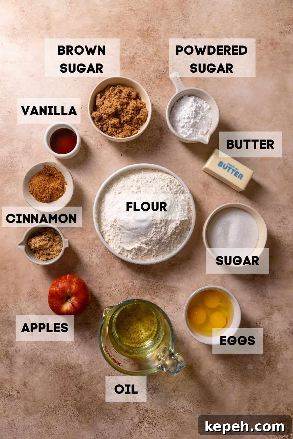 Ingredients needed to make apple cake in bowls with labels.