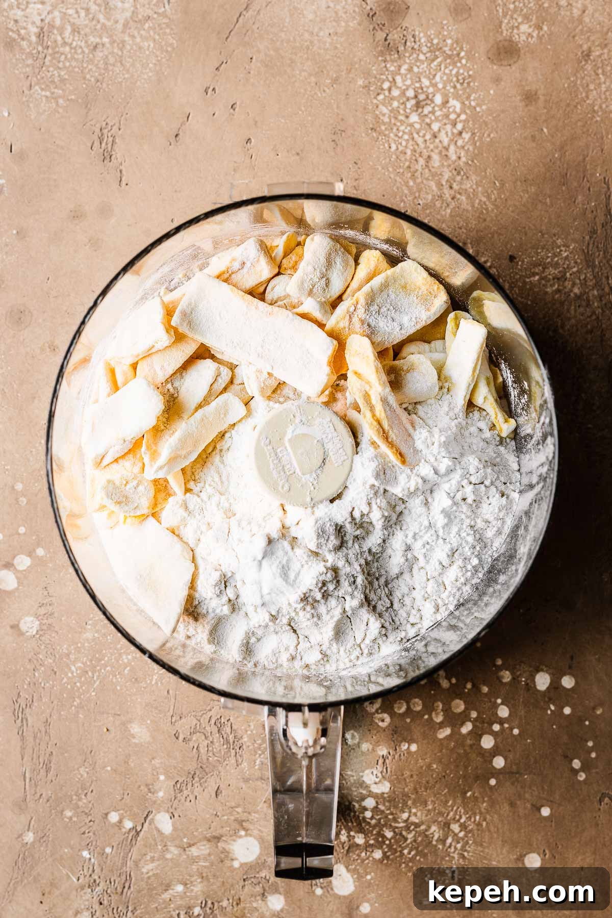 Freeze dried mangos, flour and leaveners before processing in a food processor bowl.