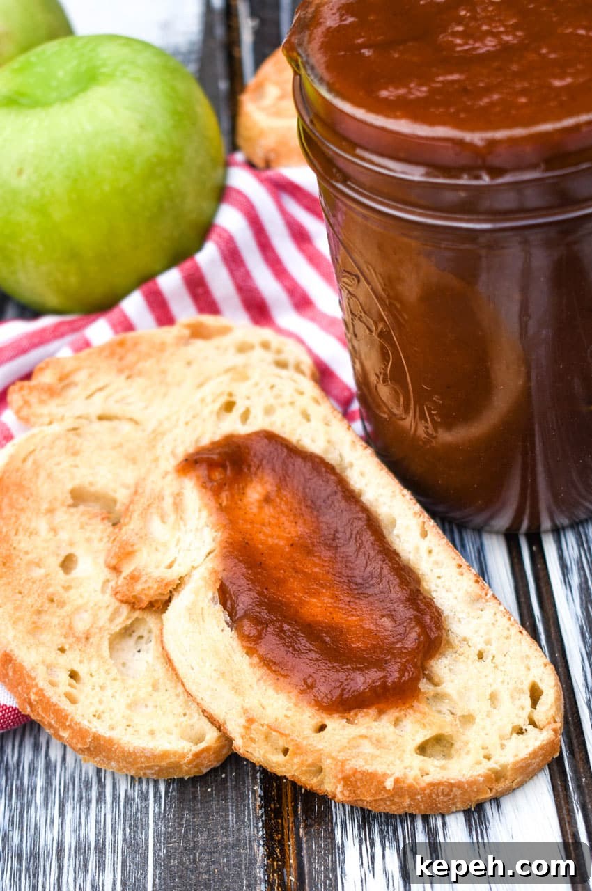 crockpot apple butter spread on a slice of toasted bread
