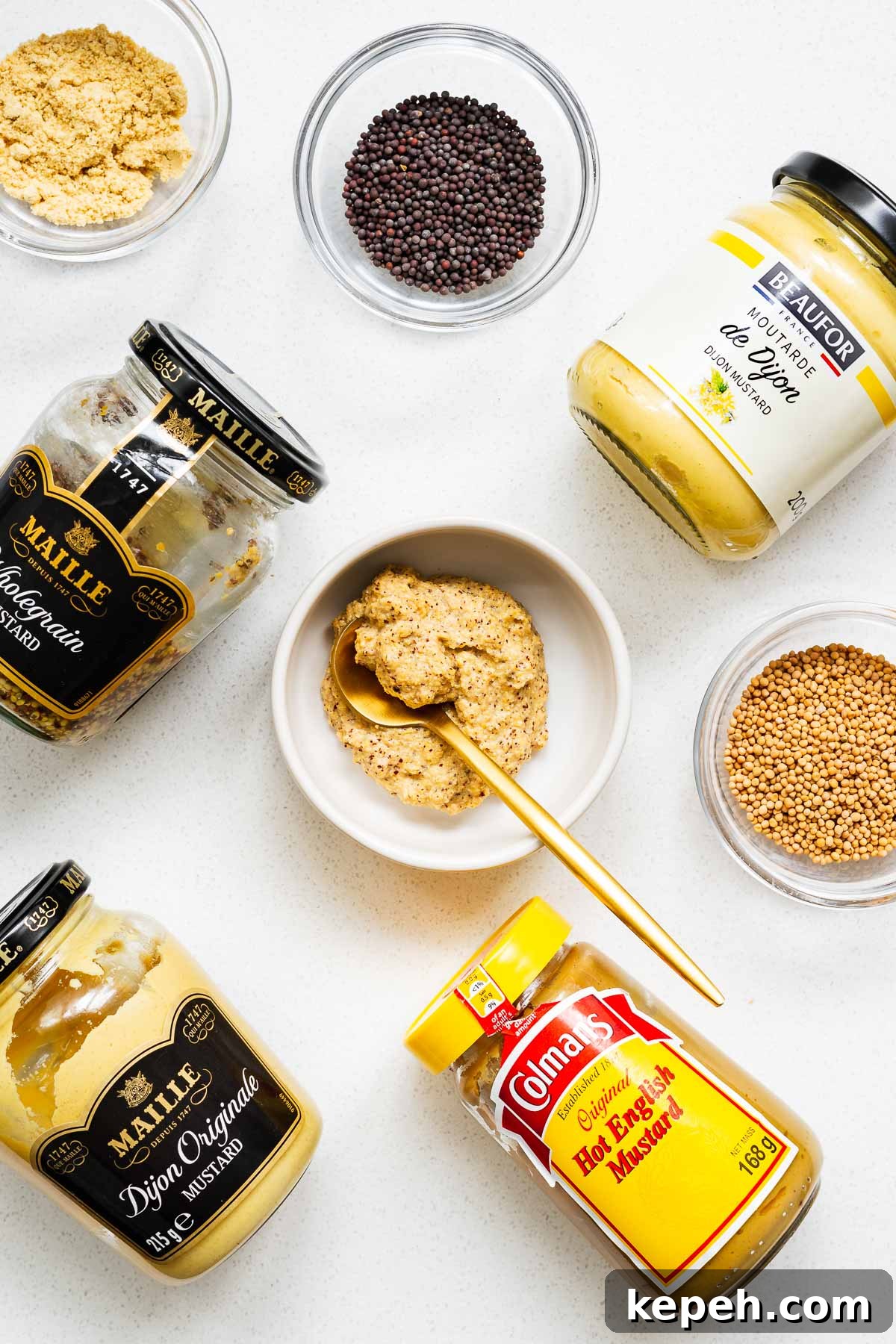 Dijon Mustard Substitutes: Recipe and Flavor Alternatives 2 Jars of Dijon mustard and suitable substitutes arranged on a kitchen towel with small bowls of mustard seeds and mustard powder.